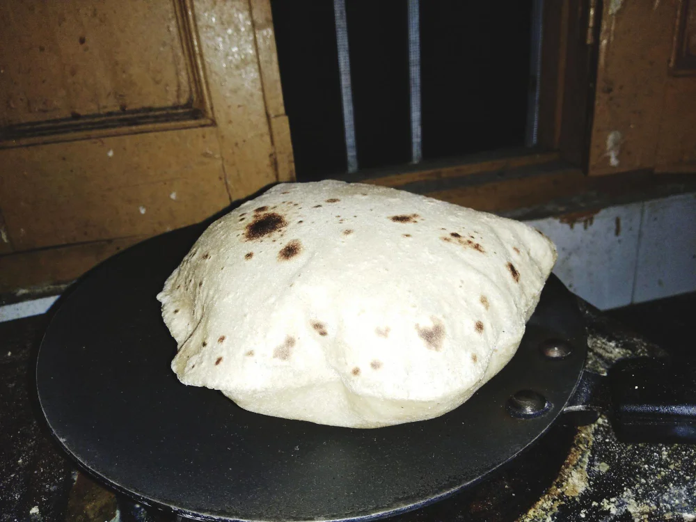 Overcooked roti on tawa showing browning and hardening, illustrating glycation process that damages skin collagen from excess sugar consumption