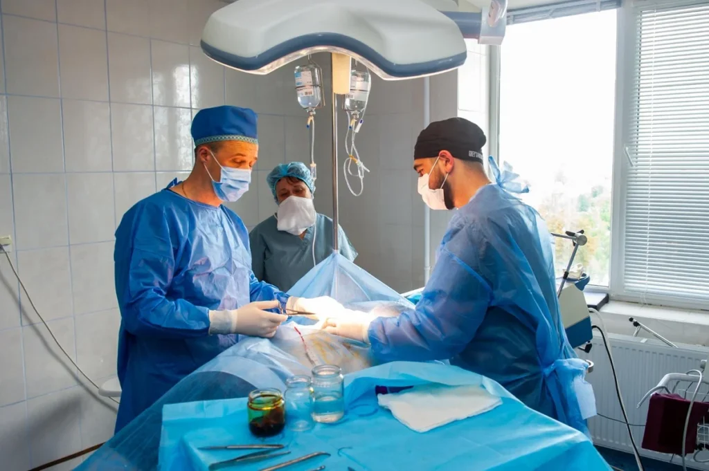 Outpatient surgery procedure being performed by surgeons in an operating room at a hospital surgical center,