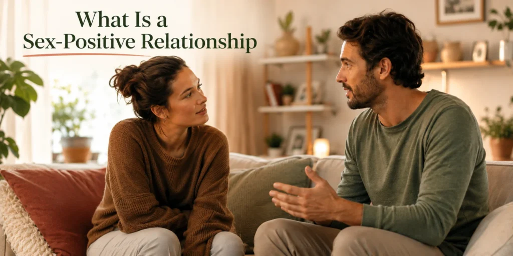 Couple having an open, honest conversation on a couch at home, illustrating what a sex-positive relationship looks like